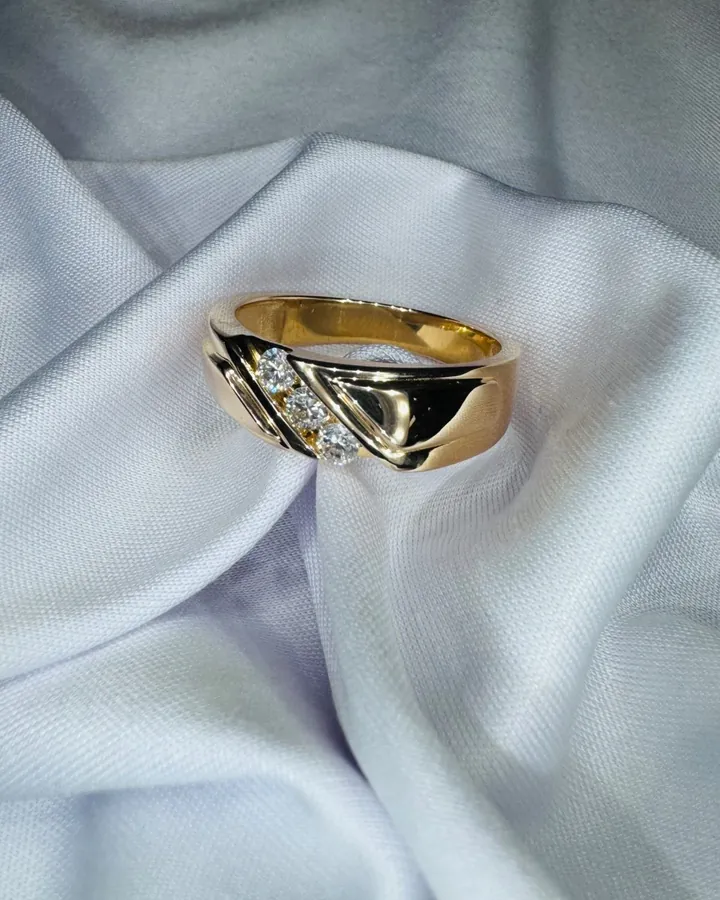 Men's sculptural yellow gold band with three diagonally set round diamonds