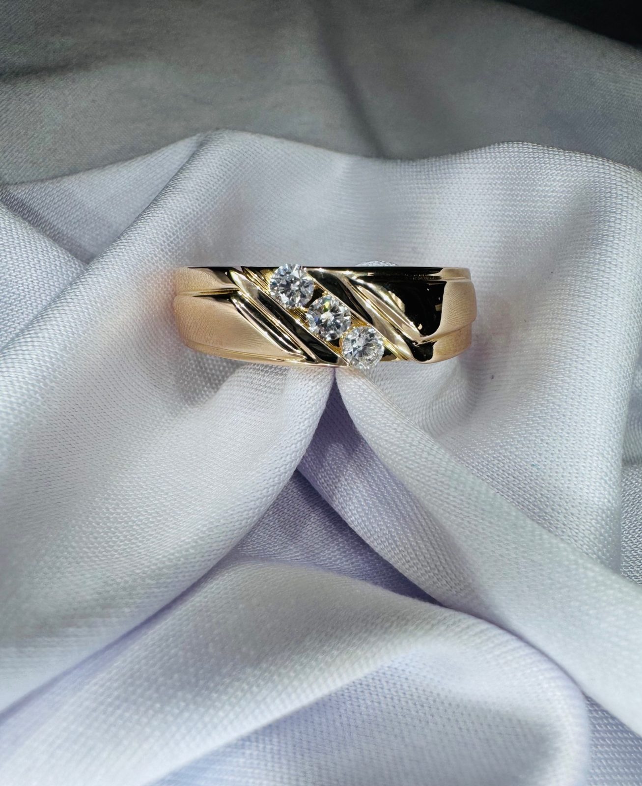 Men's yellow gold diamond band, close detail