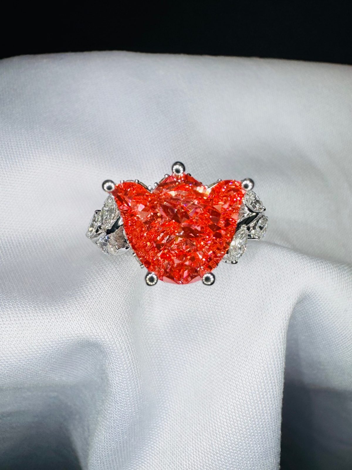 Vivid red heart-shaped stone with marquise diamond accents in white gold