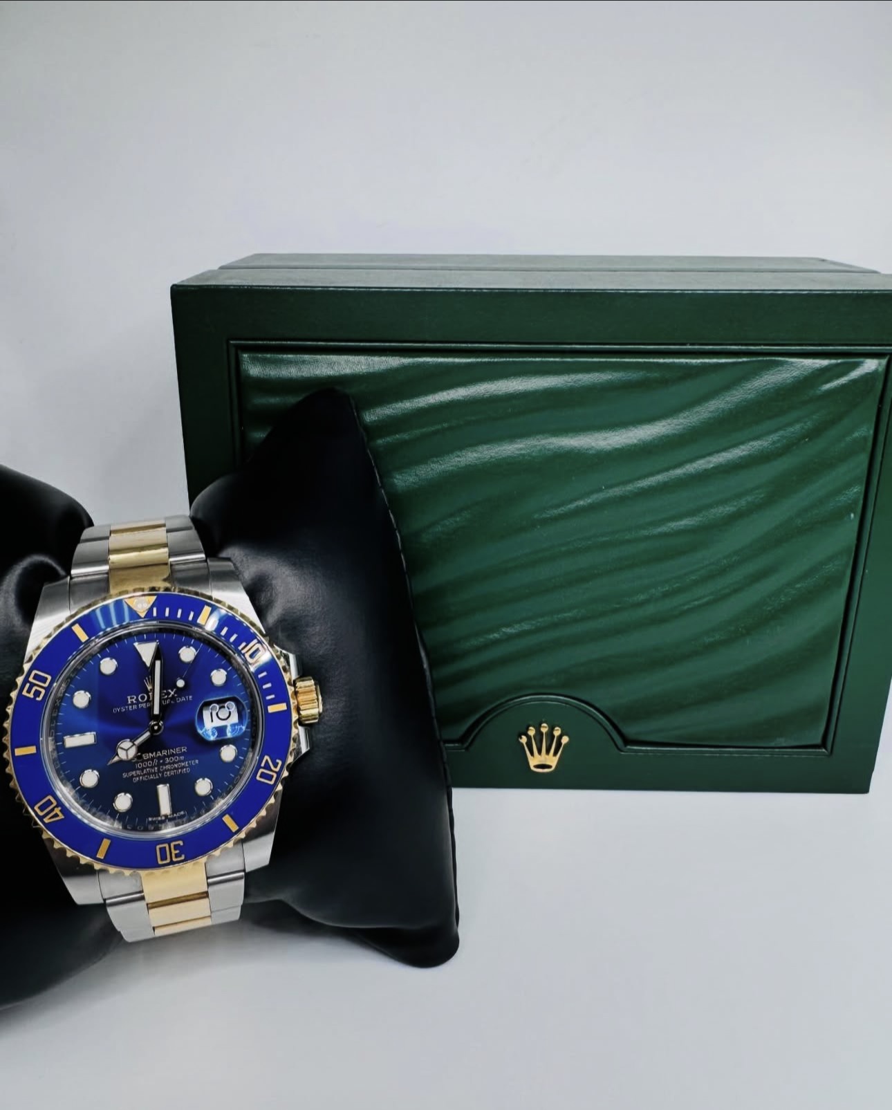 Two-tone blue-dial luxury dive watch presented with its green box
